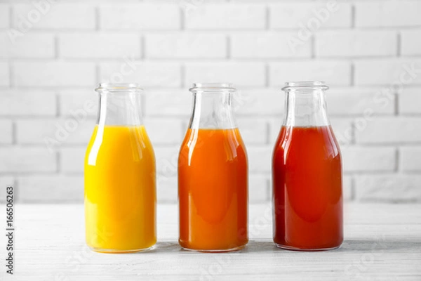 Fototapeta Delicious juices in bottles on table