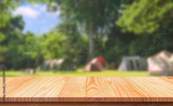 Fototapeta Empty wooden table on blurred camping tents in nature parkland background for montage product display presentation in relaxing activity and recreation on natural traveling concept