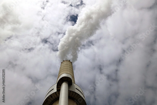 Fototapeta Amsterdam, The Netherlands - August 23rd, 2025 - Steam from the chimneys of waste incinerator AEB in Westpoort harbor
