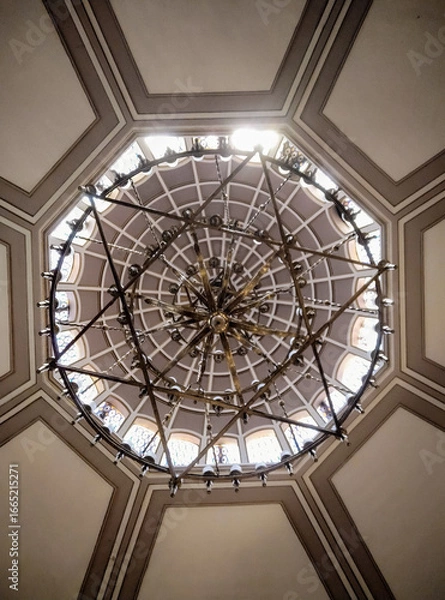 Fototapeta Symmetrical chandelier and dome ceiling with geometric architectural design, interior perspective. The photo was taken at the Neve Shalom Synagogue in Karaköy, Istanbul, Turkey.