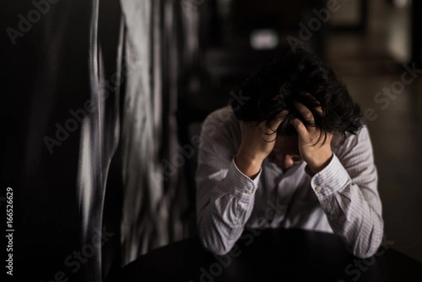 Fototapeta business man is stressed from his work.  negative thinking concept.