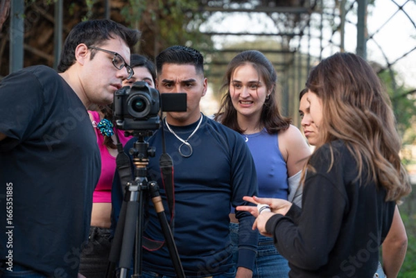 Fototapeta Filming Behind the Scenes Crew and Model Reviewing Footage