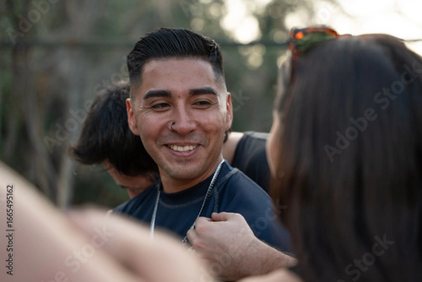 Fototapeta Man Smiling and Talking to a Woman Outdoors