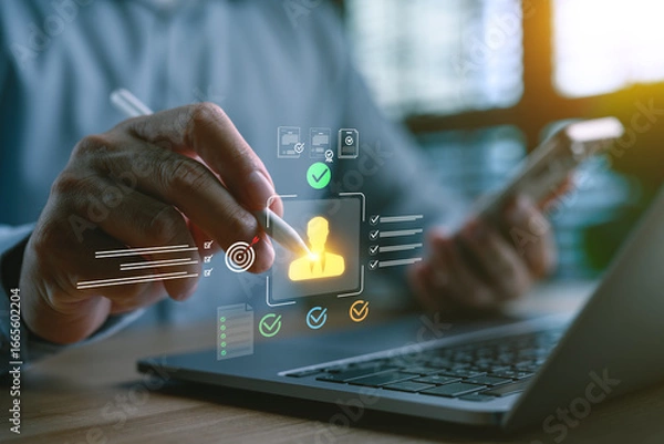 Fototapeta Hand holding stylus pointing at virtual candidate profile with checklist and approval icons on laptop screen, concept of human resources, recruitment process, employee evaluation and selection system.