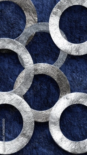 Obraz Interlocking metallic rings on a dark blue textured background