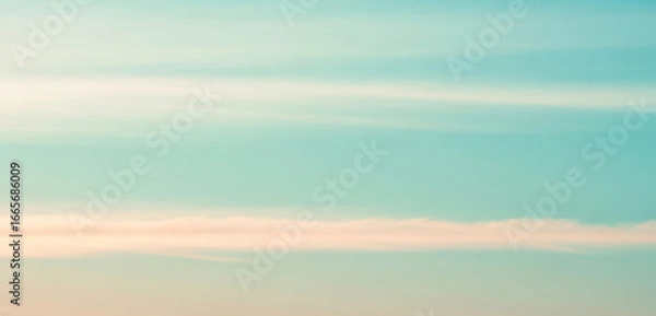 Fototapeta Abstract blurred background with teal blue and light beige colors, creating a soft dreamy atmosphere that feels calm and natural with smooth gradient tones.