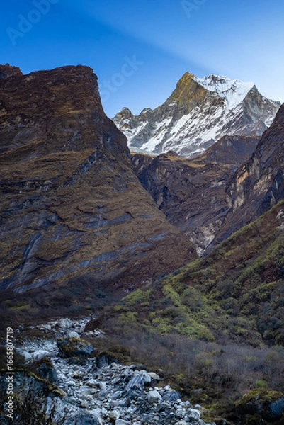 Fototapeta Mount Fishtail (Machhapuchhre) rising above deep rocky valley along the Annapurna Base Camp trekking route, Nepal