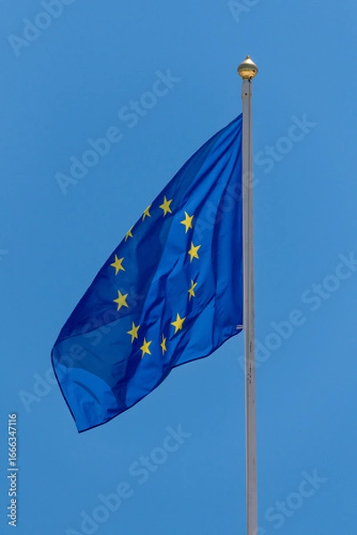 Fototapeta European Union flag waving on a tall flagpole