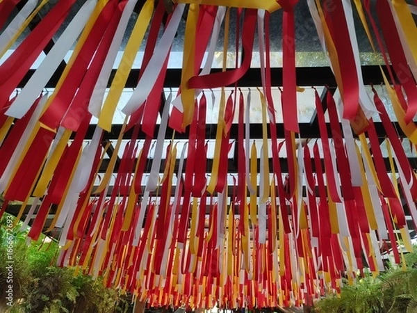 Obraz Multicolored ribbons hung over the walkway.
