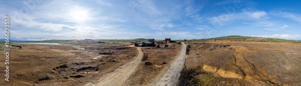 Fototapeta Expansive panoramic aerial view showcases the remnants of an abandoned copper mine in Røros, Norway, characterized by desolate terrain and industrial relics under a clear sky.