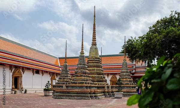 Fototapeta Colorful Buddhist Stupas and Traditional Temple Courtyard in Southeast Asia