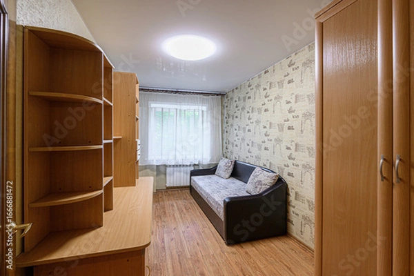 Fototapeta cozy room features a desk with shelves, a sofa with cushions, and a window with sheer curtains. Neutral wallpaper and wooden floors complete the scene