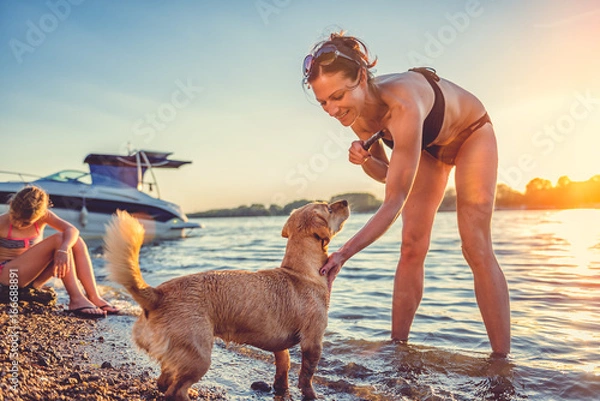 Fototapeta Mother, daughter and dog on the beach