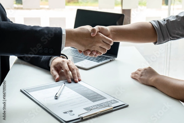 Fototapeta Good deal of interview, Business people and recruiter shaking hands greeting or get acquainted of conducting a job interview while sitting at the working meeting in office