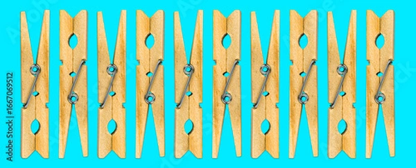 Obraz Minimalistic Wooden Clothespins on Cyan Background