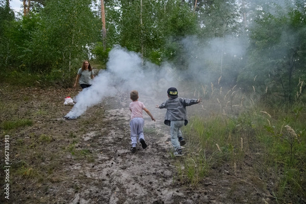Fototapeta Family Playing and Running Through Smoke in Forest Nature