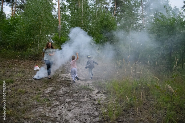 Fototapeta Family Playing and Running Through Smoke in Forest Nature