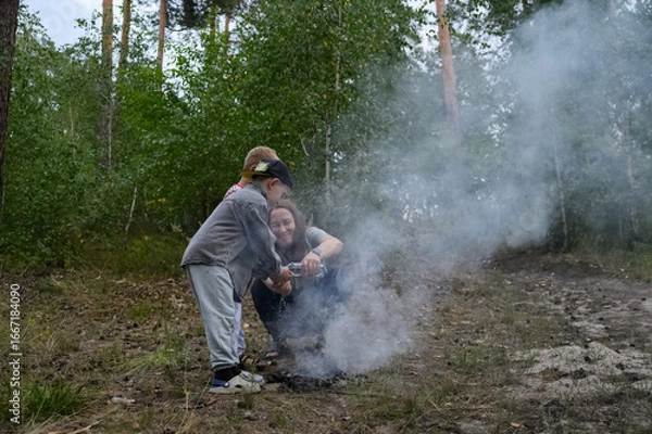 Fototapeta Family Playing and Running Through Smoke in Forest Nature