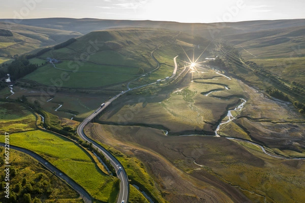 Fototapeta Aerial View of a Scenic Dry Reservoir with Winding Roads and Lush Hills
