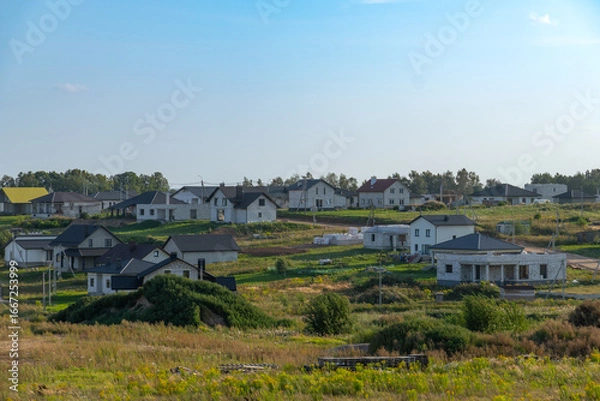 Fototapeta View of newly built modern suburban houses in a quiet residential area.