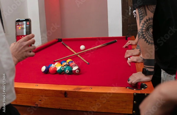 Fototapeta Pool Game in Progress Billiard Table Setup with Players