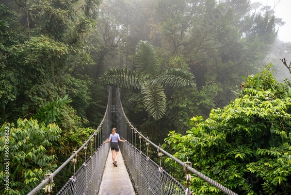 Fototapeta Walking on a suspension bridge in La Fortuna