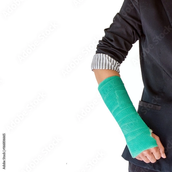 Fototapeta Closeup of a broken arm in a cast isolated on white background