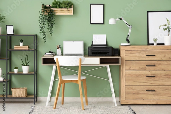 Fototapeta Workplace with modern printer, laptop and desk lamp in stylish home office