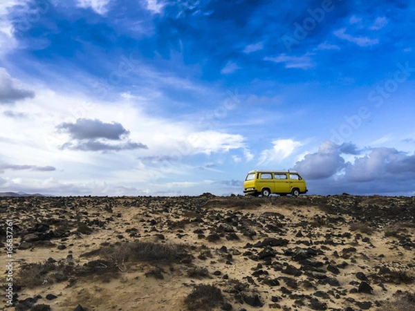 Obraz Classic yellow camper van standing in the outback of Fuerteventura in the early morning light.