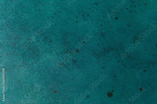 Fototapeta Textured teal wall with subtle paint speckles and aged effect