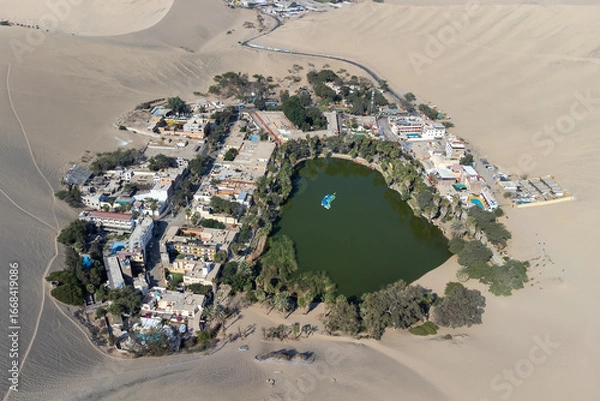 Fototapeta A stunning aerial view of the desert oasis of Huacachina, surrounded by towering sand dunes in the Ica region of Peru