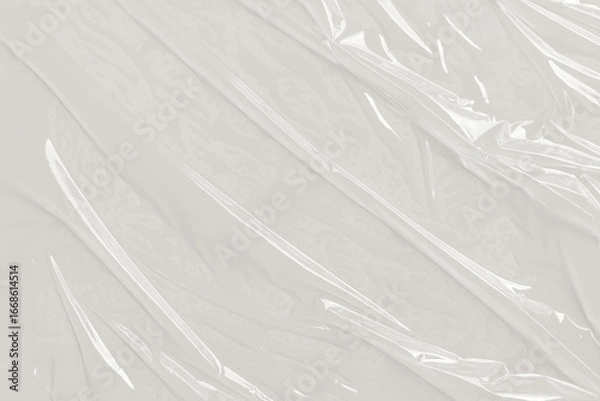 Fototapeta Wrinkled, creased plastic wrap with reflections  texture. Used for abstract backgrounds, packaging design, or digital overlays in design projects.