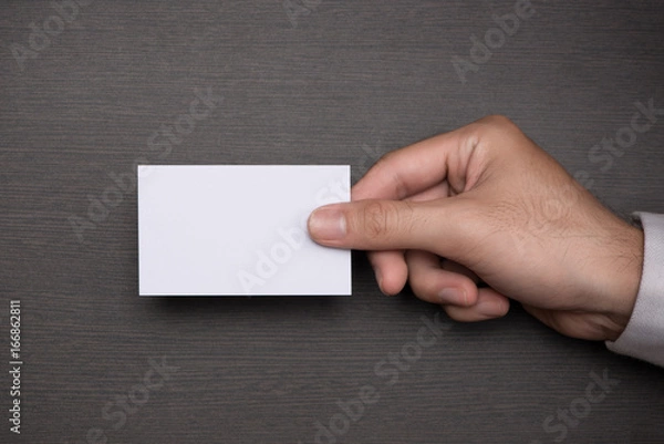 Fototapeta Mockup of white business cards in man's hand