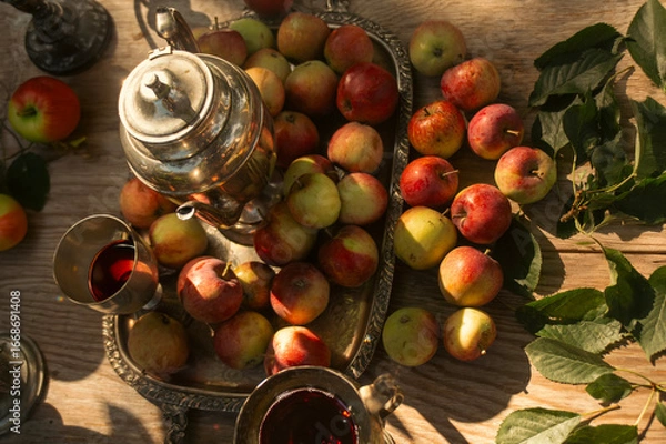 Fototapeta Still life composition of ripe apples arranged in a garden setting.