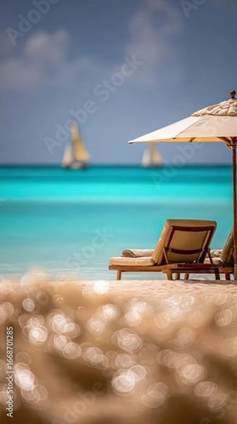 Fototapeta Relaxing beach scene with loungers and sailboats in the distance