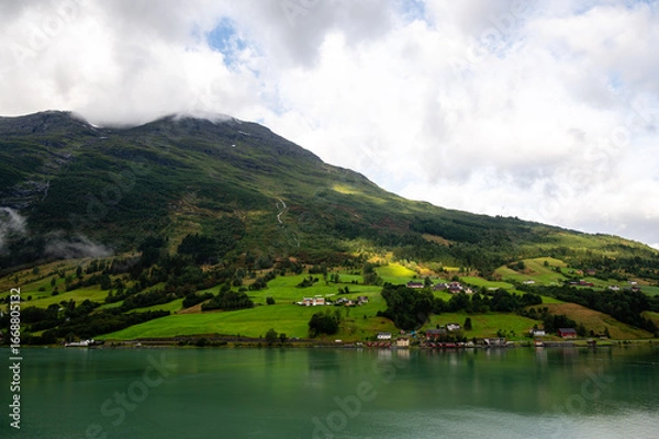 Fototapeta Norway villages in fjord on near olden. Cloudy Nordic day.