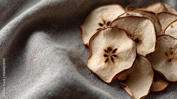 Fototapeta Flat lay with dried apple slices on textured neutral fabric