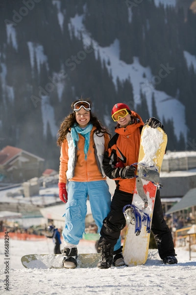Obraz Lucky couple  snowboarders  in a mountain valley