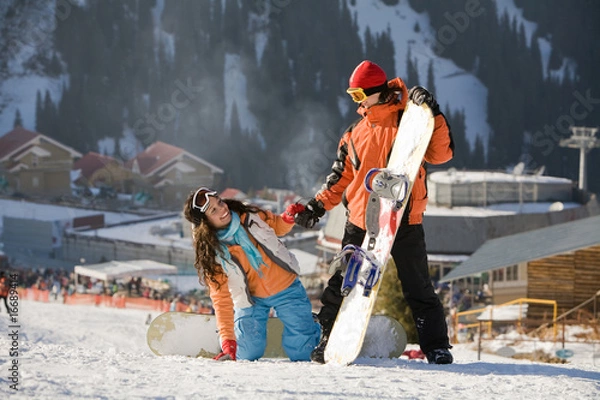 Obraz Lucky couple  snowboarders  in a mountain valley