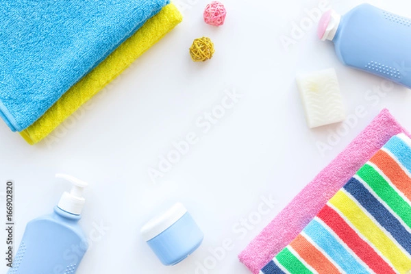 Fototapeta Personal care. Towels, soap and shampoo, cream on white backgrond top view copyspace