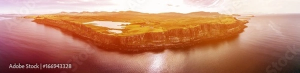Fototapeta Cinematic aerial shot of the dramatic coastline at the cliffs close to the famous Kilt Rock waterfall ,Skye