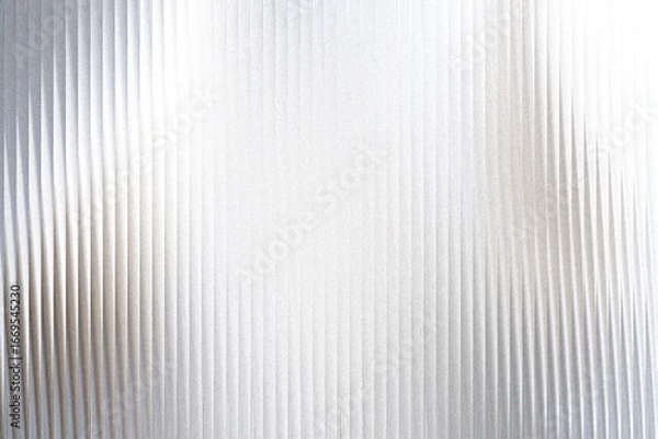 Fototapeta A closeup view of a textured surface with vertical ribbed lines and a shimmering, speckled effect, creating a sense of depth and abstract beauty