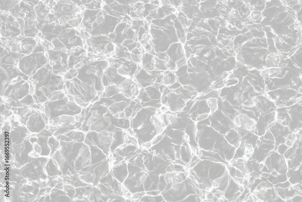 Fototapeta Shimmering, sunlit water surface shows intricate light patterns, casting subtle shadows. Light reflects and refracts, creating movement and depth