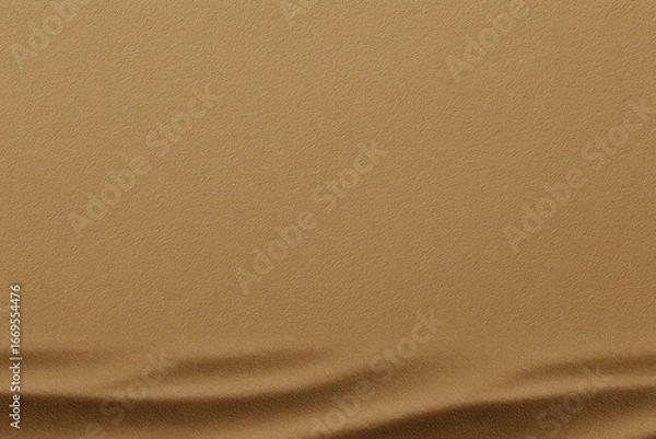 Fototapeta Simple, earthy scene a flat tan surface fading into subtly wavy, darker shadows at the bottom, creating a minimal, abstract landscape