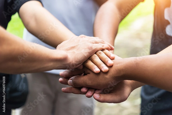 Fototapeta Teamwork concept,Business team standing hands together in the loft office.people joining for cooperation success business,win in every thing,vintage color
