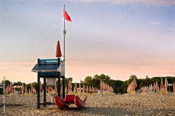 Obraz Lifeguard tower on a beach with rescue boat.