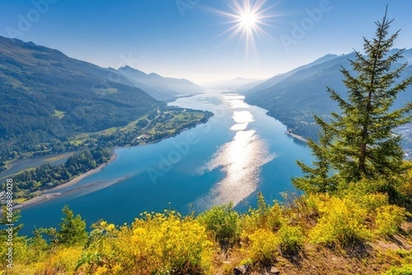 Fototapeta High-angle view of a serene lake nestled in a mountainous valley, bathed in sunlight