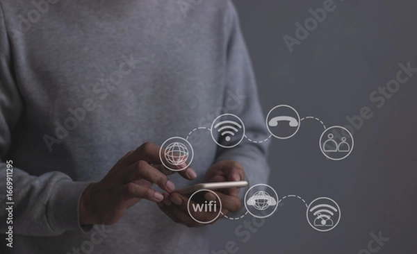 Fototapeta Young man hand using smartphone with to Interconnect, Interconnected Concept; People connect via wireless internet in a world of digital technology and communications that connect