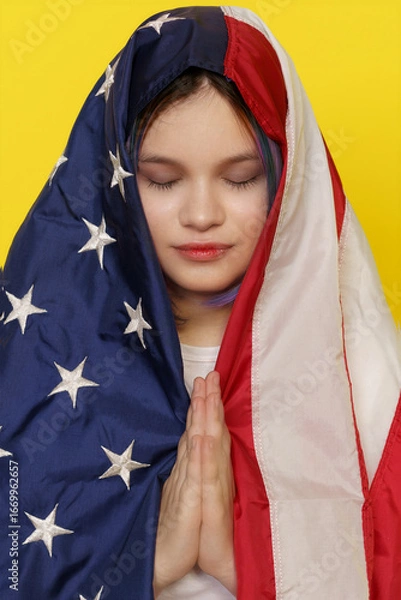Fototapeta A young Asian woman gracefully wraps herself in an American flag, eyes closed in meditation. Vibrant colors and cultural elements blend in a striking artistic display of identity.
