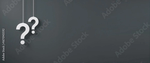 Fototapeta Frequently asked questions concept with two hanging white question mark symbols on a wide panoramic gray banner with copy space for text